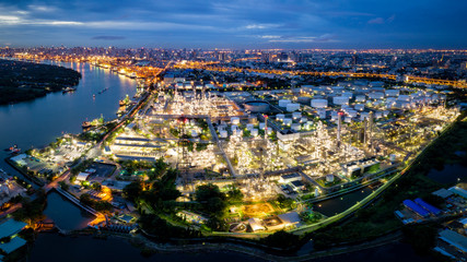 Fototapeta premium Aerial view of oil refinery near international port at night. Panorama of refinery plant at night. refinery factory and tank