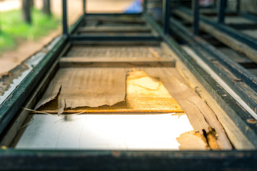Old broken tables and chairs in school for sale.
