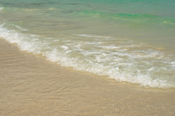 Fototapeta na wymiar blue sea wave on sandy the beautiful beach background summer concept.