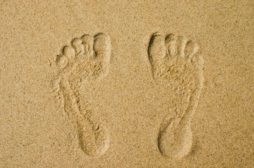 couple footprint on sandy the beautiful beach background summer concept.