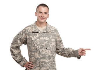 Army Soldier Smiling and Pointing on Studio White Background