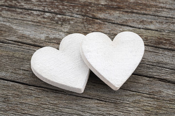 Two hearts on old wooden background
