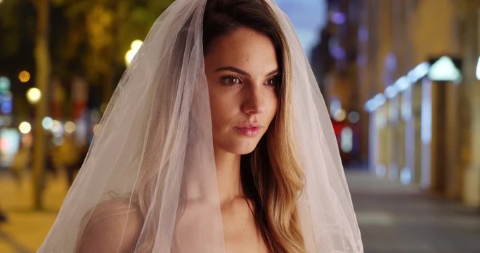 Close up side view of beautiful bride on the Champs-Elysees, Caucasian woman wearing traditional veil on city street in Paris, 4k