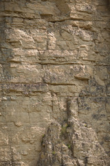 impressive huge steep wall in a surface quarry, stone texture, can be used as background