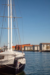 COPENHAGEN, DENMARK - MAY 6, 2018: yacht moored in harbour and beautiful cityscape in copenhagen, denmark