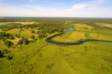 The valley of the  Sorot river in the solar June morning (aerial photography). Pushkinskie Gory, Russia