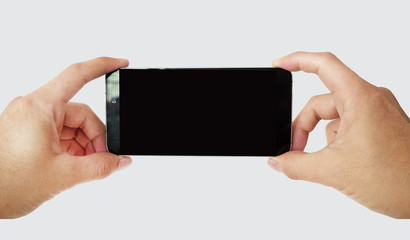 Man hand holding the black smartphone with blank screen. Borderless blank screen design - isolated on white background. Mockup have clipping path Layer.