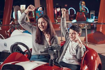 Fototapeta na wymiar Happy smiling mother and son in amusement center