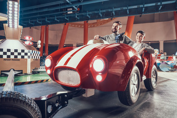 Happy smiling father and son in amusement center