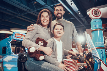 Happy family sitting on toy motorbike
