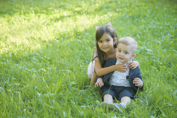 Family, children, brother and sister on green grass