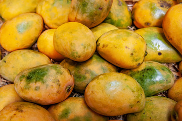 full frame image of pile of yellow mangoes