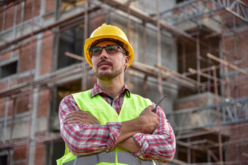 Naklejka na ściany i meble Construction supervisor inspecting building site