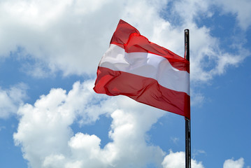 Austrian flag in front of summer sky