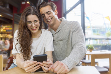 Smiling couple using in a restaurant