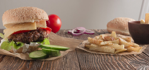 Delicious burgers with beef, tomato, cheese and lettuce