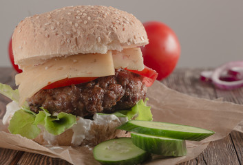 Delicious burgers with beef, tomato, cheese and lettuce
