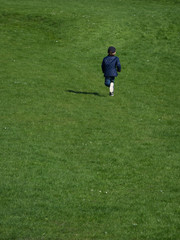 Child is playing on the green