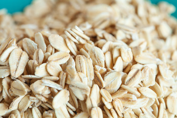 Oats flakes in dish on wood table