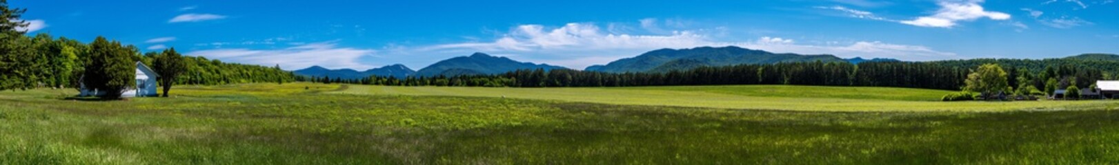 Panoramic view of a house in a glade within Adirondacks Mountains - obrazy, fototapety, plakaty