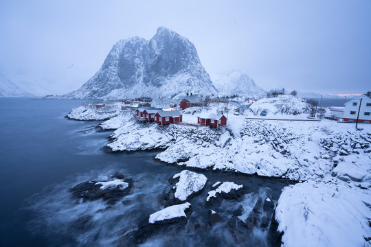 Hamnoy village after heavy snow at night all the red houses are covered with snow with haze scene / Landscape Photography