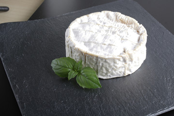brie cheese on a stone background