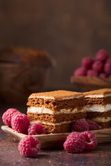 Layered honey cake with cream and raspberries.