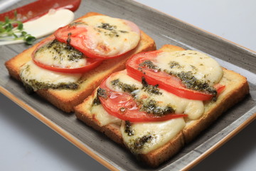 Two tomato and cheese sandwiches