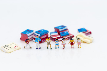 Miniature people: Children's group with teaching equipment. Image use for back to school