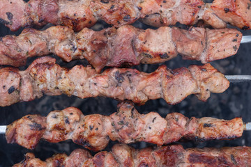 cooking barbecue pork on the coals