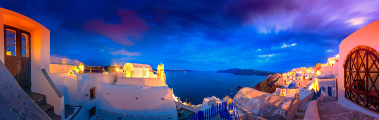 Oia town on Santorini island, Greece. Traditional and famous houses and churches with blue domes...
