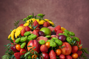 a beautiful bouquet of fruits and flowers for the birthday of strawberries grape peaches