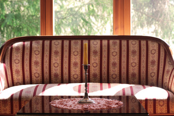 Biedermeier sofa and a table  in front of a large window