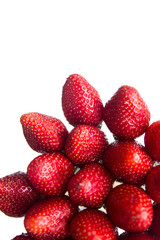 A few healthy red strawberries on a white background