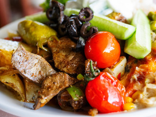 Healthy dinner - plate full of stewed vegetables, rice and meat with natural yogurt.