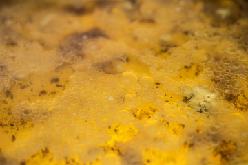 A mixture of fat, water and detergent in a frying pan