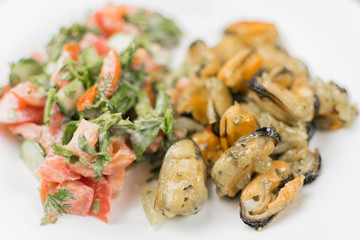 Fried mussels with fresh vegetable salad.