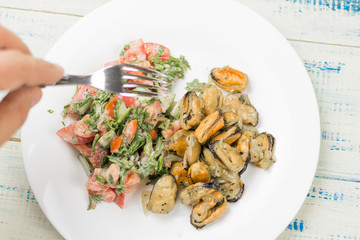 Fried mussels with fresh vegetable salad.