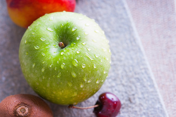 Fresh fruits on a wooden cutting board 