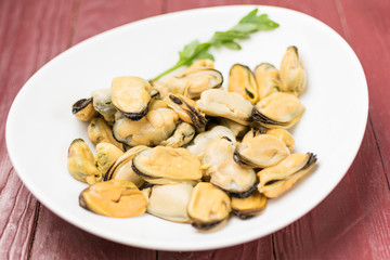 Peeled mussels on a white background.