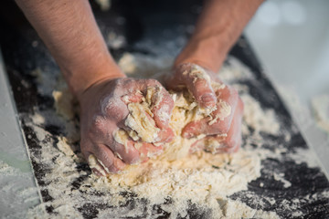 a man prepares the dough