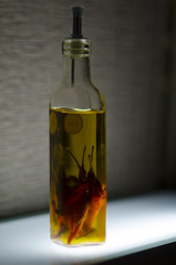 a bottle of oil with red pepper