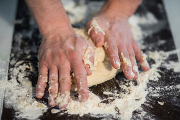a man prepares the dough