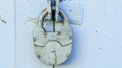 Old lock on the iron door of the garage door