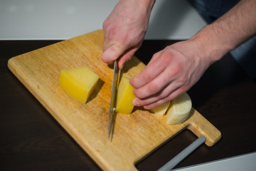 man cuts cheese