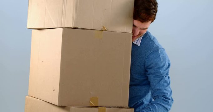 Man carrying stack of cardboard boxes against white background 4k