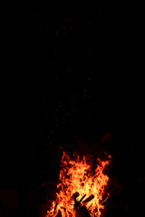 Fototapeta na wymiar Fire Flame & Sparks on Dark Black Background
