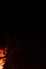 Fototapeta na wymiar Fire Flame & Sparks on Dark Black Background