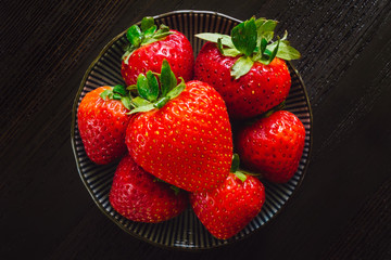 Bowl of Strawberries on Dark Table