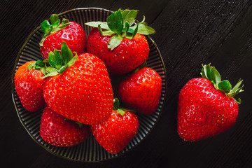 Fresh Strawberries in Bowl and on Wood Table
